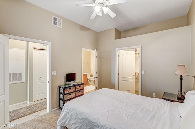 bedroom featuring ensuite bath, ceiling fan, and light carpet