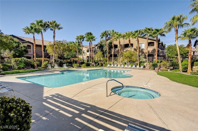 view of swimming pool featuring a patio area and a hot tub