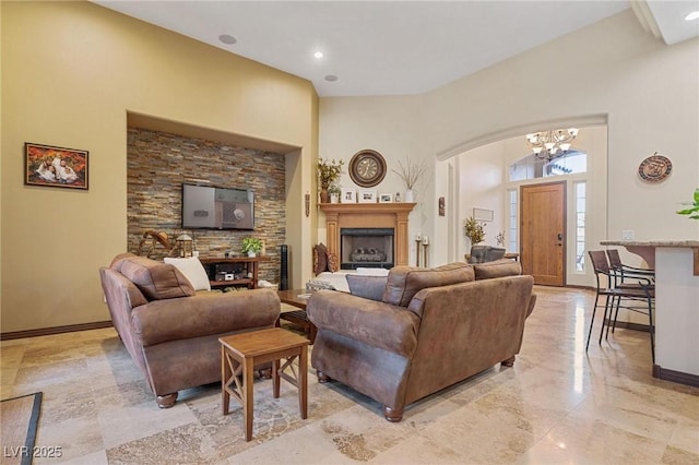 living room featuring a towering ceiling and a chandelier