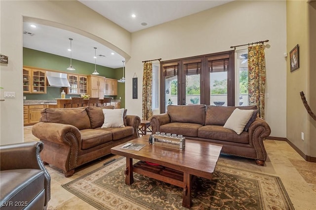 living room with high vaulted ceiling