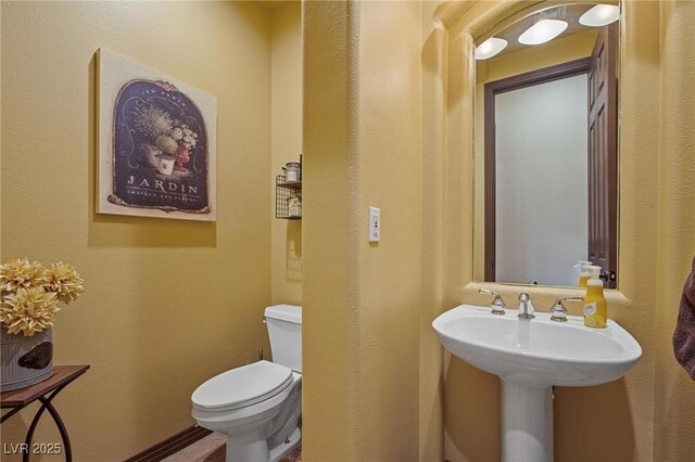 bathroom featuring toilet