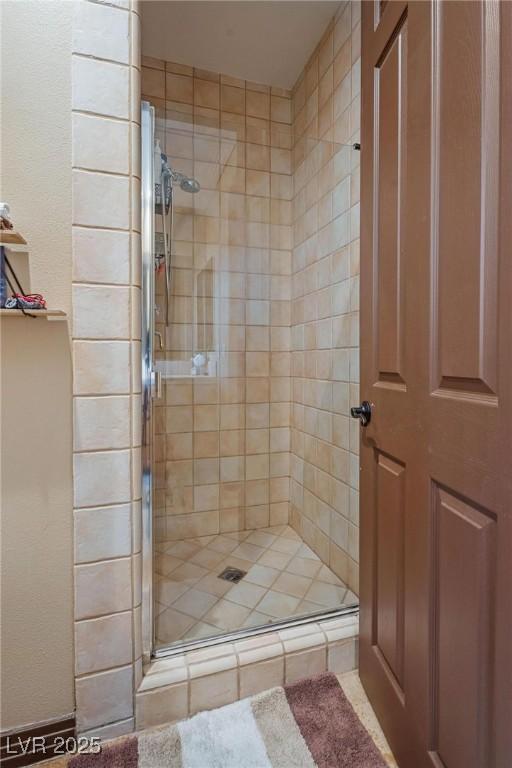 bathroom featuring a shower with shower door