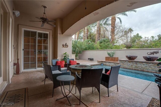 view of patio with a fire pit and ceiling fan