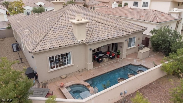 rear view of property featuring a pool with hot tub, central AC unit, and a patio