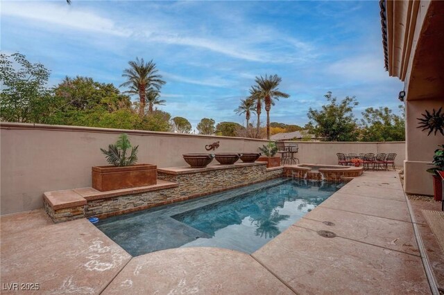 view of swimming pool with a patio and an in ground hot tub