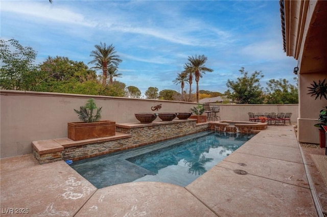 view of pool featuring a patio area and a pool with connected hot tub