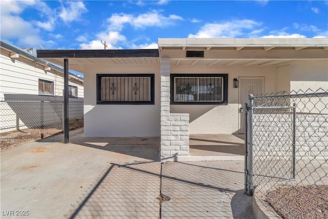 doorway to property featuring a carport