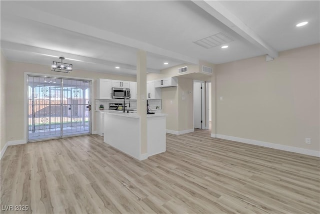 kitchen featuring a chandelier, light hardwood / wood-style floors, beamed ceiling, pendant lighting, and white cabinetry