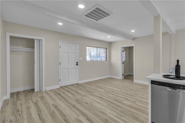 kitchen with light hardwood / wood-style floors, dishwasher, and beam ceiling