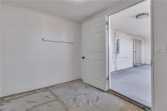 interior space with electric panel and concrete floors