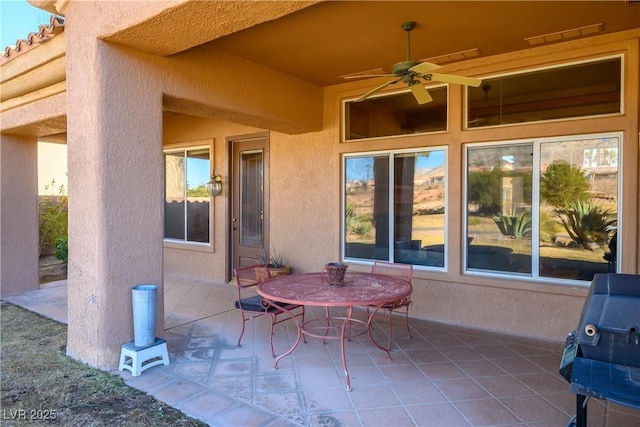 view of patio featuring ceiling fan