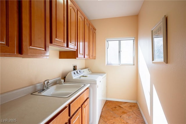 washroom with sink, cabinets, and independent washer and dryer