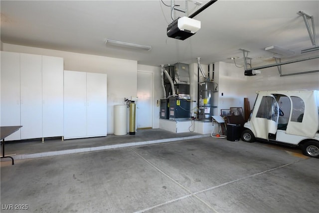 garage featuring a garage door opener, water heater, and heating unit