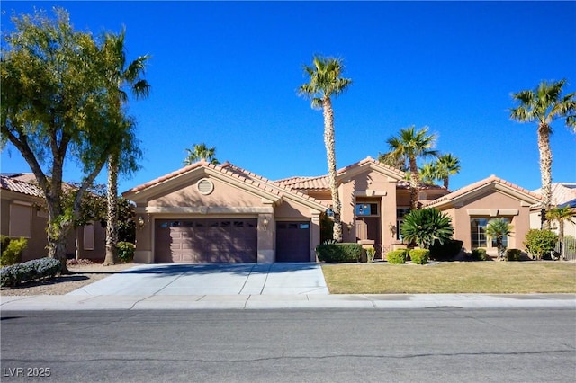 mediterranean / spanish-style house with a front lawn and a garage