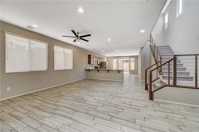 unfurnished living room featuring ceiling fan