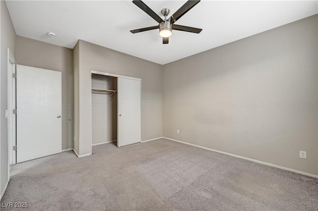 unfurnished bedroom featuring ceiling fan, light colored carpet, and a closet