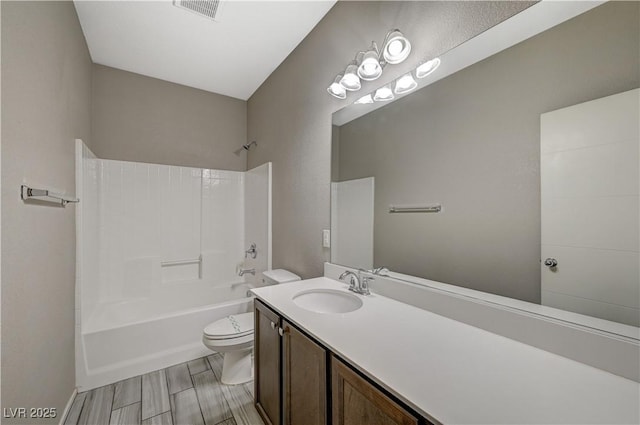 full bathroom featuring toilet, vanity, and  shower combination