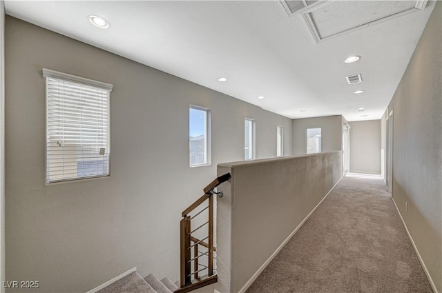 hallway featuring light carpet