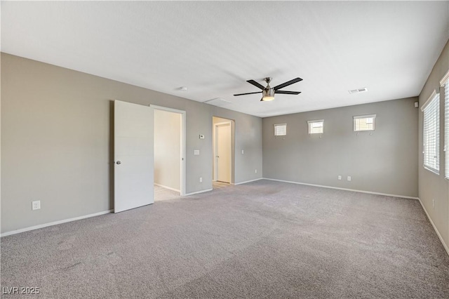 carpeted spare room with ceiling fan