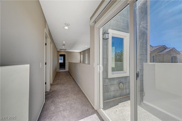 corridor with light colored carpet