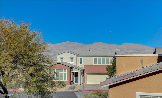 view of front of house featuring a garage and a mountain view