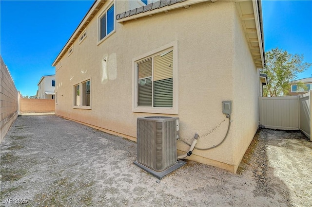 view of property exterior with central AC and a patio area