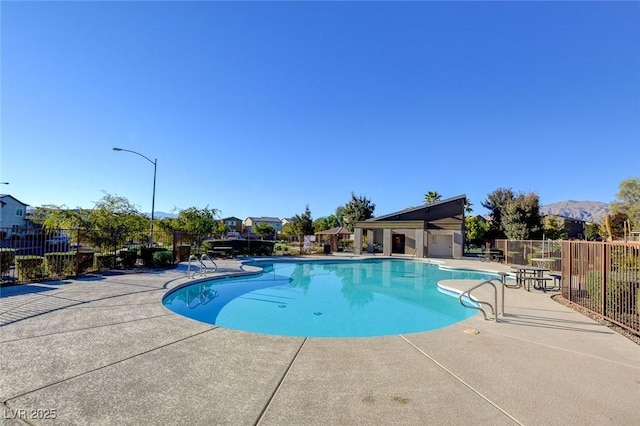 view of pool featuring a patio area and a mountain view