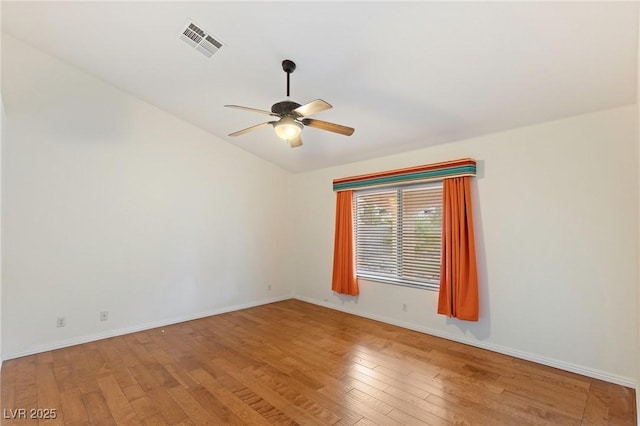 empty room featuring ceiling fan, wood-type flooring, and lofted ceiling