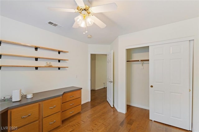 unfurnished bedroom with a closet, ceiling fan, and light wood-type flooring