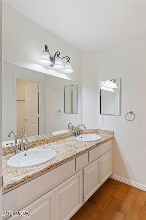 bathroom with hardwood / wood-style flooring and vanity