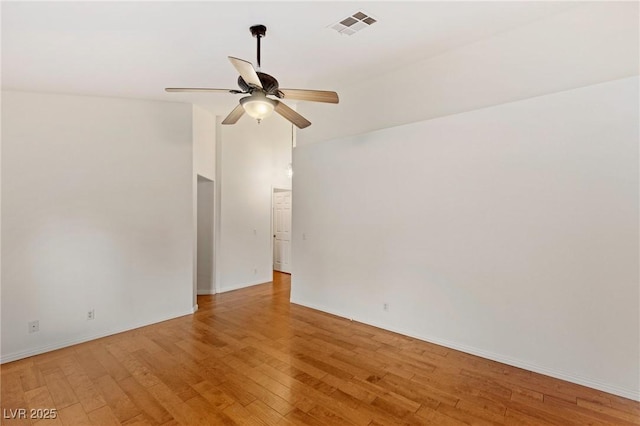 spare room with hardwood / wood-style floors and ceiling fan