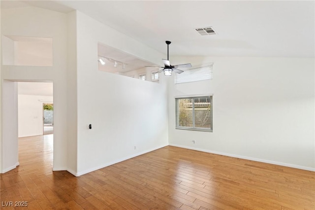 unfurnished room featuring hardwood / wood-style floors, high vaulted ceiling, and ceiling fan