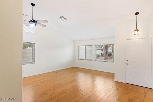 unfurnished living room featuring vaulted ceiling, ceiling fan, and light hardwood / wood-style flooring