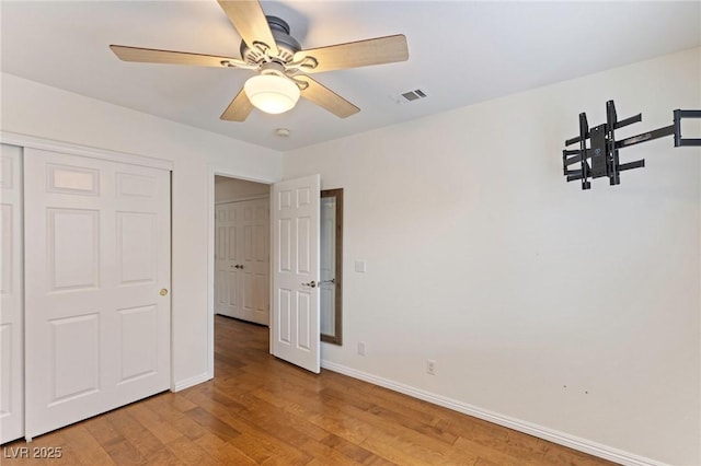 unfurnished bedroom with a closet, ceiling fan, and light hardwood / wood-style flooring