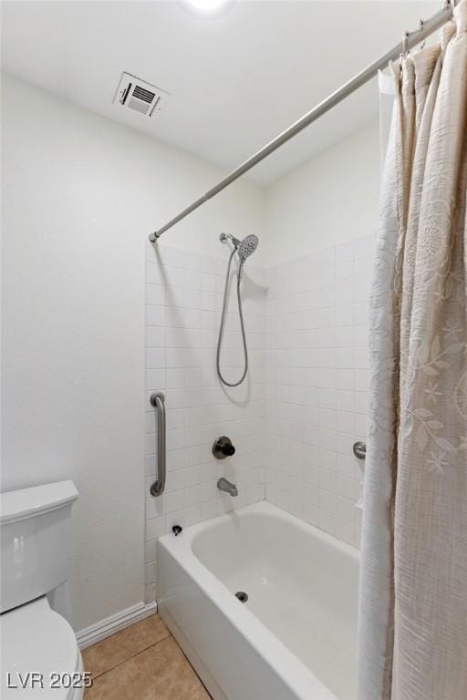 bathroom featuring shower / tub combo with curtain, toilet, and tile patterned flooring