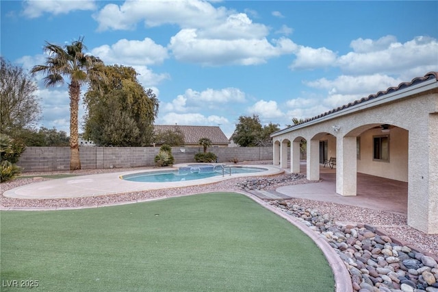 view of swimming pool featuring ceiling fan and a patio area