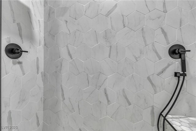 interior details featuring a tile shower