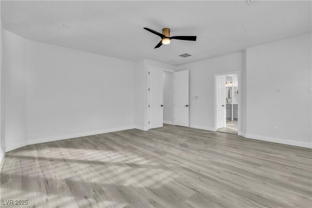 empty room featuring ceiling fan and light hardwood / wood-style floors