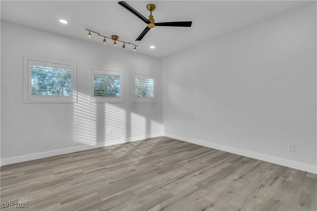 empty room featuring ceiling fan and light hardwood / wood-style floors