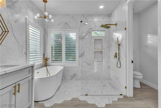 full bathroom with toilet, a notable chandelier, plus walk in shower, and vanity