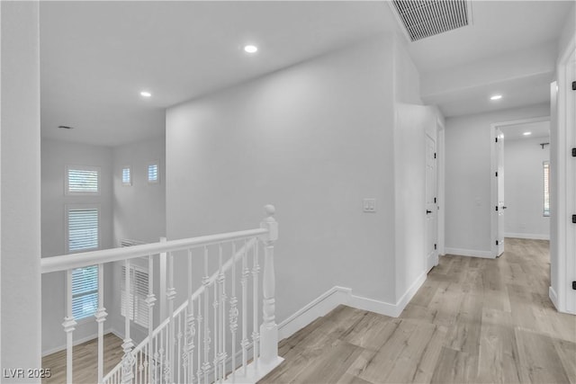 hallway with light hardwood / wood-style flooring