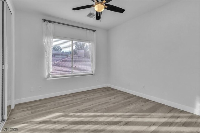 spare room with ceiling fan and light hardwood / wood-style flooring