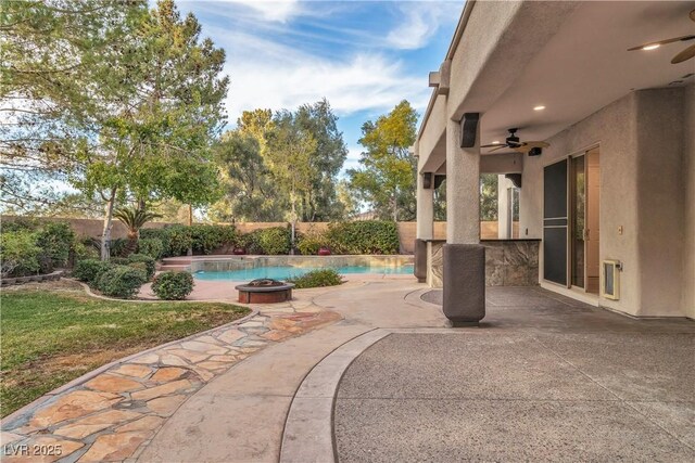 view of patio featuring ceiling fan, an outdoor bar, and an outdoor fire pit