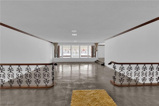 staircase featuring ornamental molding, concrete floors, and a textured ceiling