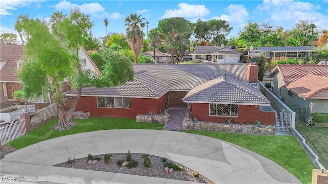 ranch-style home with a front lawn