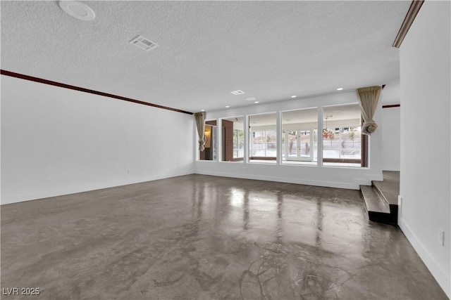 unfurnished living room featuring concrete floors and a textured ceiling