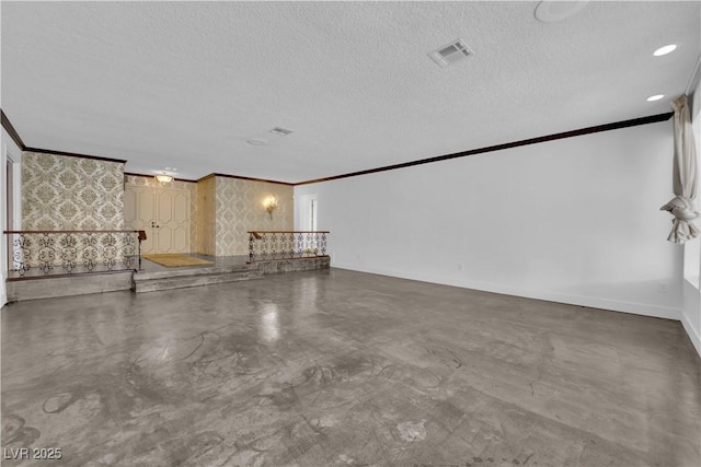 interior space featuring ornamental molding, a textured ceiling, and concrete floors