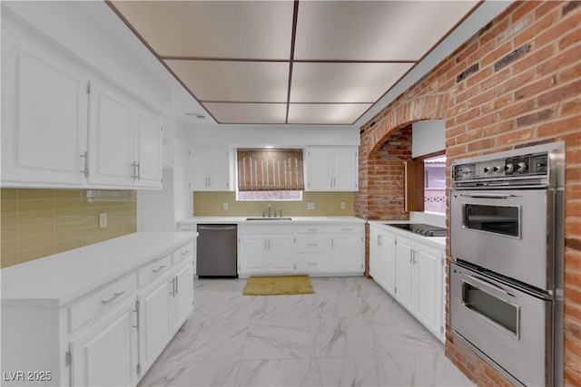 kitchen featuring white cabinetry, appliances with stainless steel finishes, and sink