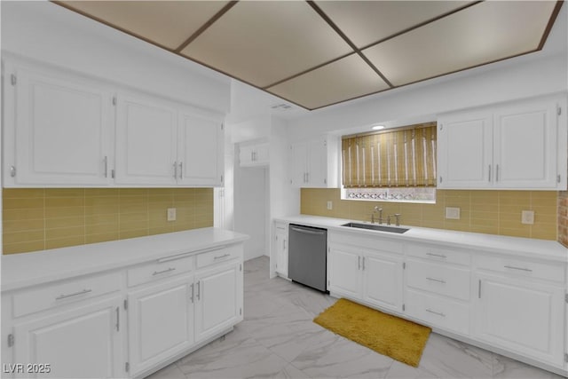 kitchen with sink, dishwasher, decorative backsplash, and white cabinetry