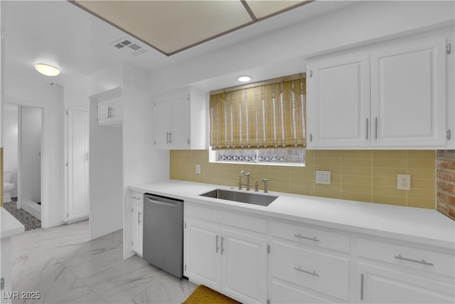 kitchen featuring stainless steel dishwasher, sink, and white cabinets